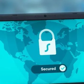 A padlock over a world map on a screen, with the word Secured