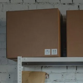 Cardboard boxes stacked on a warehouse shelf